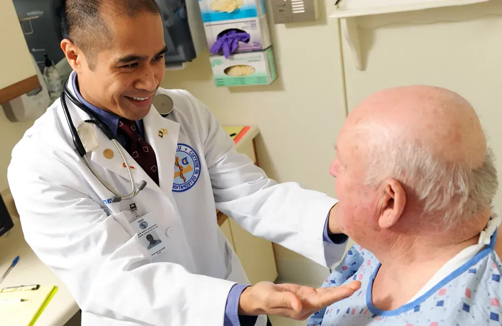 A D O student performs an exam on a patient